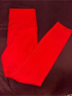 Athleta Elation 7/8 leggings in coral red size small with laser cut detail